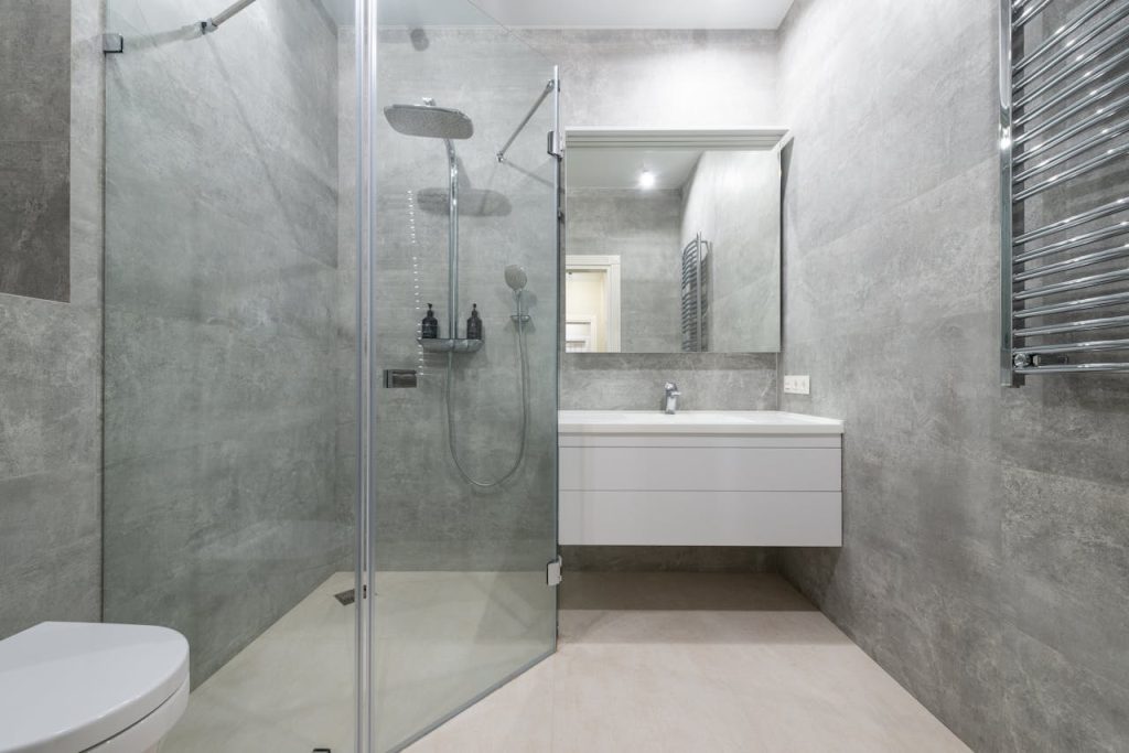 Stylish modern bathroom with glass shower and minimal decor.